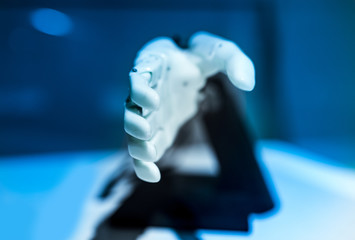 plastic robot hand with open palm gesture