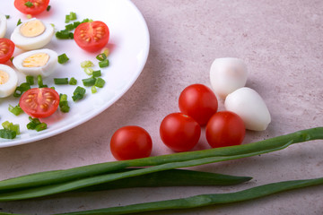 natural nutritious diet vegetable salad of tomatoes and quail eggs
