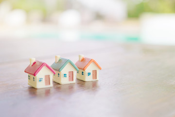 Fototapeta na wymiar Miniature house on wooden background.Image for property real est