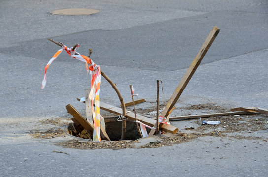 Open sewer well on the roadway