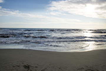 Waves at sunset, the beach at Italy - Summer season