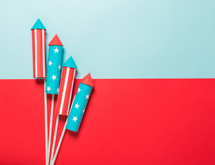 July 4, rockets for fireworks on a blue red background with space for text. in the style of...