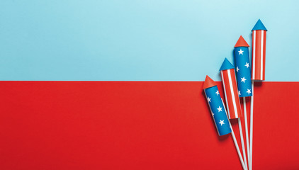 July 4, rockets for fireworks on a blue red background with space for text. in the style of...
