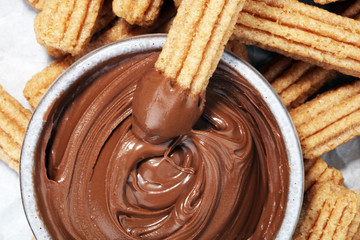 Traditional Spanish dessert churros with sugar and chocolate