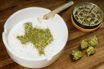 Ground weed in the shape of Texas with a joint. (series)