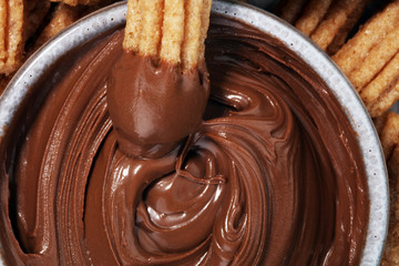 Traditional Spanish dessert churros with sugar and chocolate