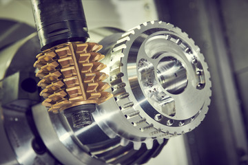 cogwheel milling process. Industrial CNC metal machining by hobbing cutter mill