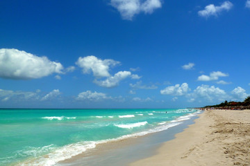 Tropical beach, sea, waves and sky with clouds