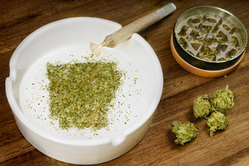 Ground weed in the shape of Arkansas with a joint. (series)