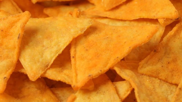 Close up of rotating nacho chips. No sound.