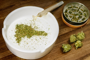 Ground weed in the shape of Dominican Republic with a joint. (series)