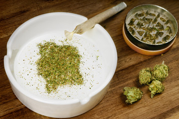Ground weed in the shape of Ivory Coast with a joint. (series)