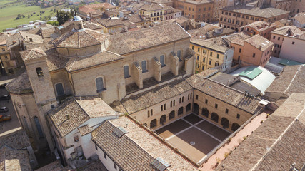 Fototapeta na wymiar Aerial view of the inner courtyard of an ancient medieval church built of bricks. The church is located in the historic center of Osimo in the Marche.