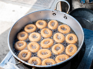Donut fried maker making machine with stainless steel mold optional, frying sweet and tasty donuts on hot oil in a pan