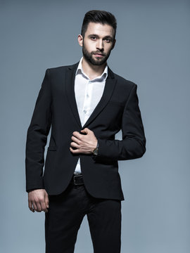 Handsome man in black suit with white shirt