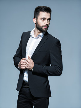 Handsome man in black suit with white shirt