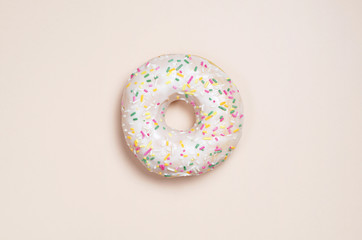 Fototapeta na wymiar Glazed donut with colorful sprinkles