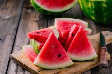 Fresh sliced watermelon on wooden rustic background © nblxer