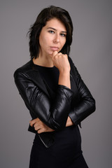 Fototapeta premium Young beautiful woman against gray background