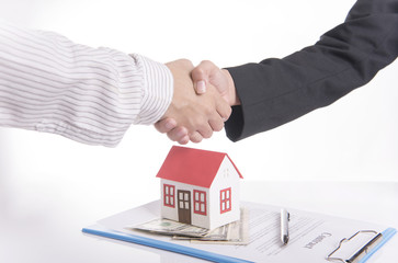 salesman agent handshake with customer after agreement contract sale home.