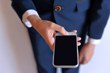 The phone is in the hands of the student. Hands of a boy with a phone.