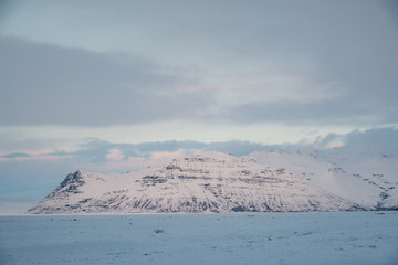 Dramatic icelandic landscape with snow covered mountains. Cold winter day in Iceland.