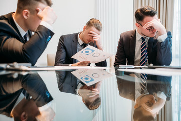business failure. prospective bankruptcy. stressed stunned crushed defeated team of company...