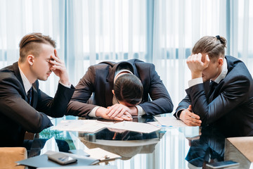 business failure. prospective bankruptcy. stressed stunned crushed defeated team of company...