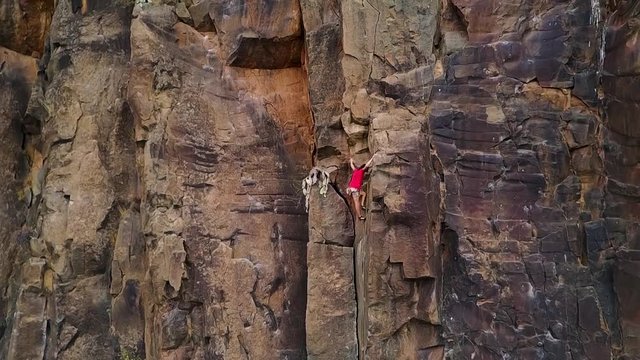 Slow motion of man climbing a rock wall in a canyon - Climber training outdoor in a rocky spot - Travel, adrenaline and extreme dangerous sport concept