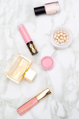 Set of decorative cosmetics on a marble background. Vertical photo