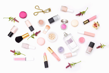 Set of decorative cosmetics of pink color on a white background. View from above