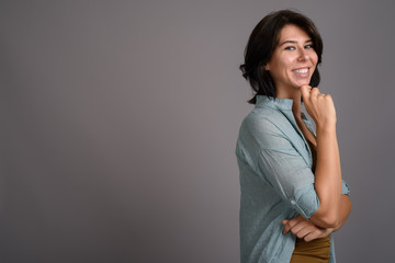 Young beautiful woman against gray background