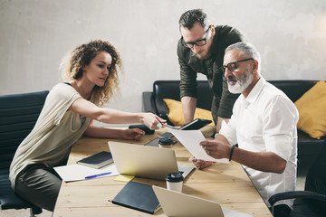 Young team of coworkers making great work discussion in modern office.Bearded man talking with marketing director and assistant manager.Business people meeting concept.
