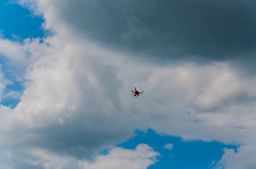 A drone flying in a cloudy sky making tricks. Concept of operating a quadrocoper