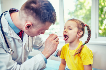 The doctor is a pediatrician in his office, he is taking a reception.