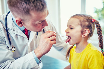 The doctor is a pediatrician in his office, he is taking a reception.