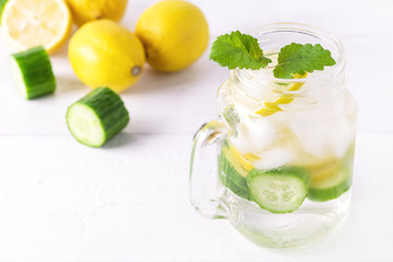 Infused Water With Lemon Cucumber and Mint on Wooden Background Detox Water Above Lemonad