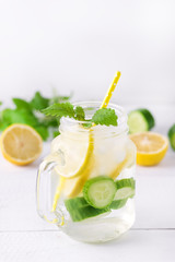 Infused Water With Lemon Cucumber and Mint on Wooden Background Detox Water Vertical Lemonad
