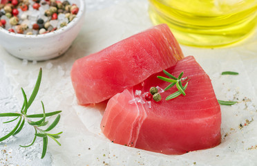 Raw Tuna fish steaks with sea salt, pepper and rosemary