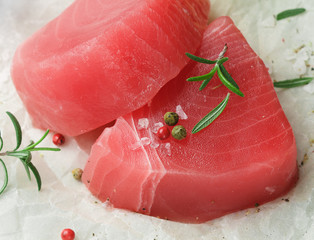 Raw Tuna fish steaks with sea salt, pepper and rosemary