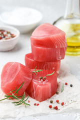 Raw Tuna fish steaks with sea salt, pepper and rosemary