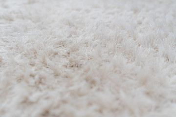 Fototapeta na wymiar Luxury white wool carpet texture background, selective soft focus for background