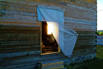 wooden house for a rural plot in the evening