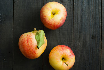 apples on black wooden table background