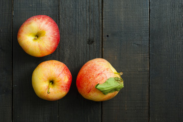 apples on black wooden table background