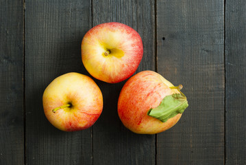 apples on black wooden table background