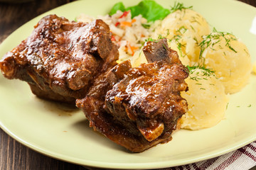 Pork spare ribs served with mashed potatoes and sauce