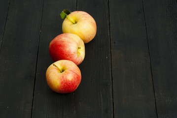 apples on black wooden table background