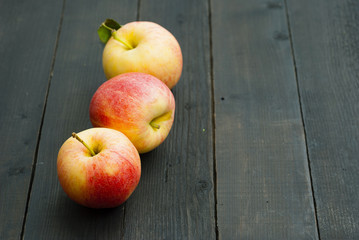 apples on black wooden table background