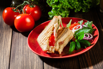 Toasted panini with ham, cheese and tomato sandwich